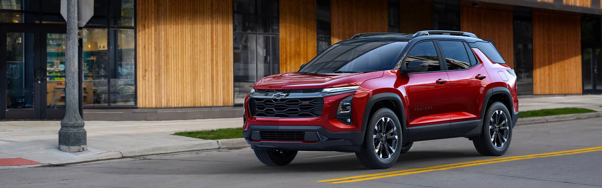 2025 Chevrolet Equinox in red parked in town