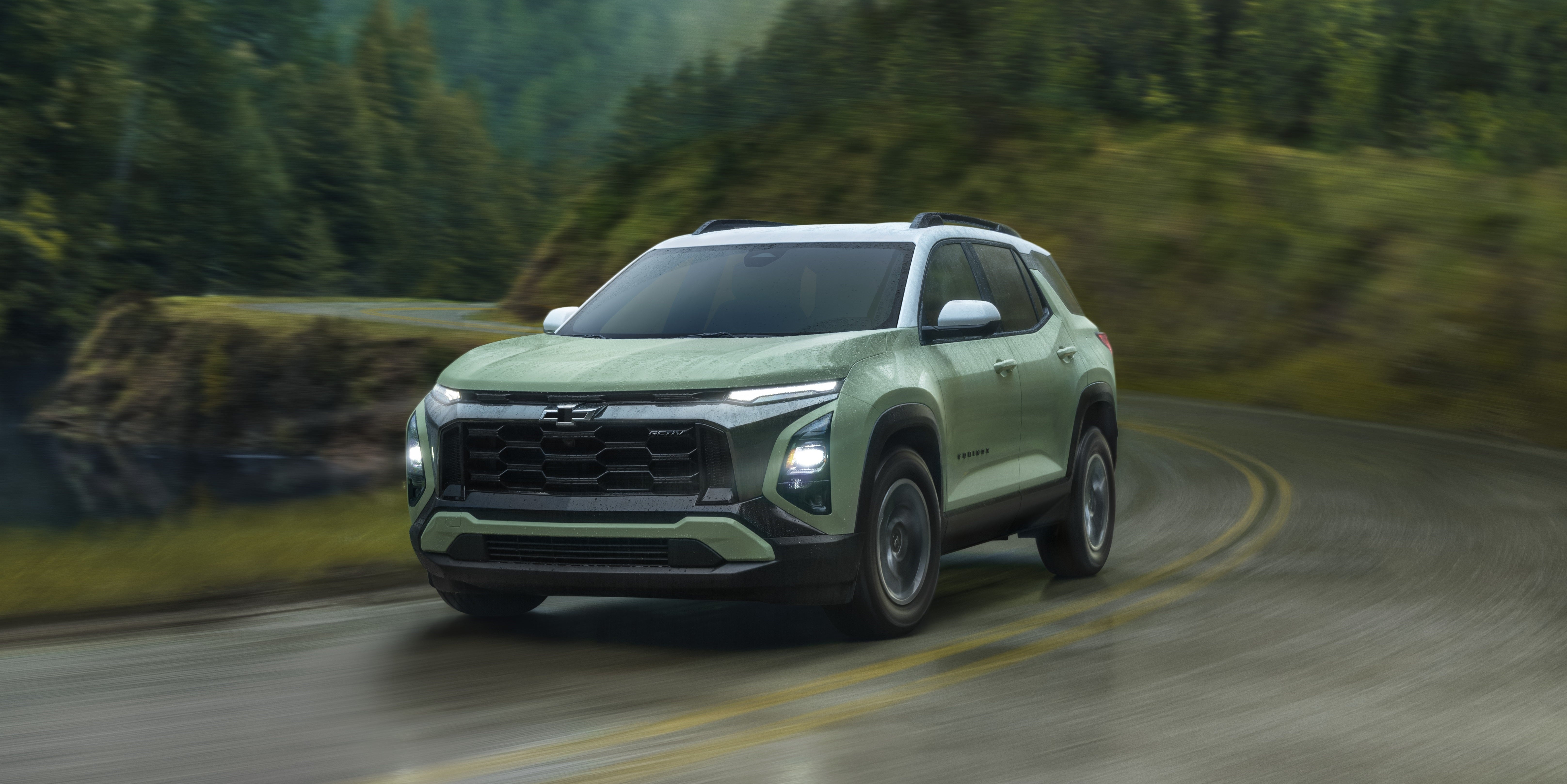2025 Chevrolet Equinox in green driving in the rain with headlights on