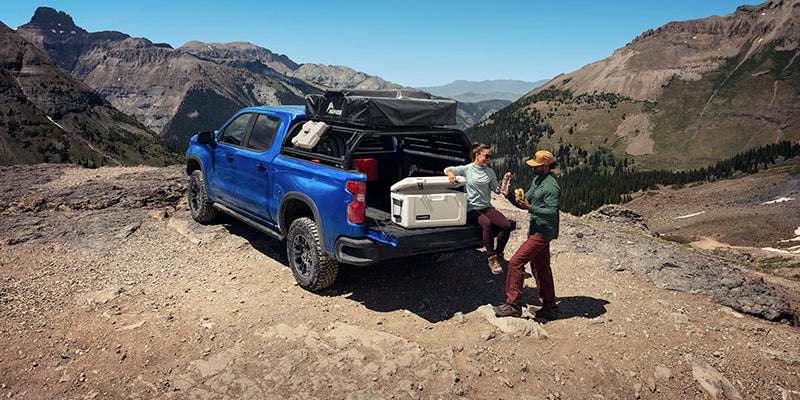 family parked and sitting in the bed of their 2025 Chevrolet Silverado