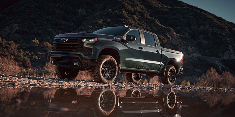 side view of a 2025 Chevrolet Silverado parked in front of a giant puddle