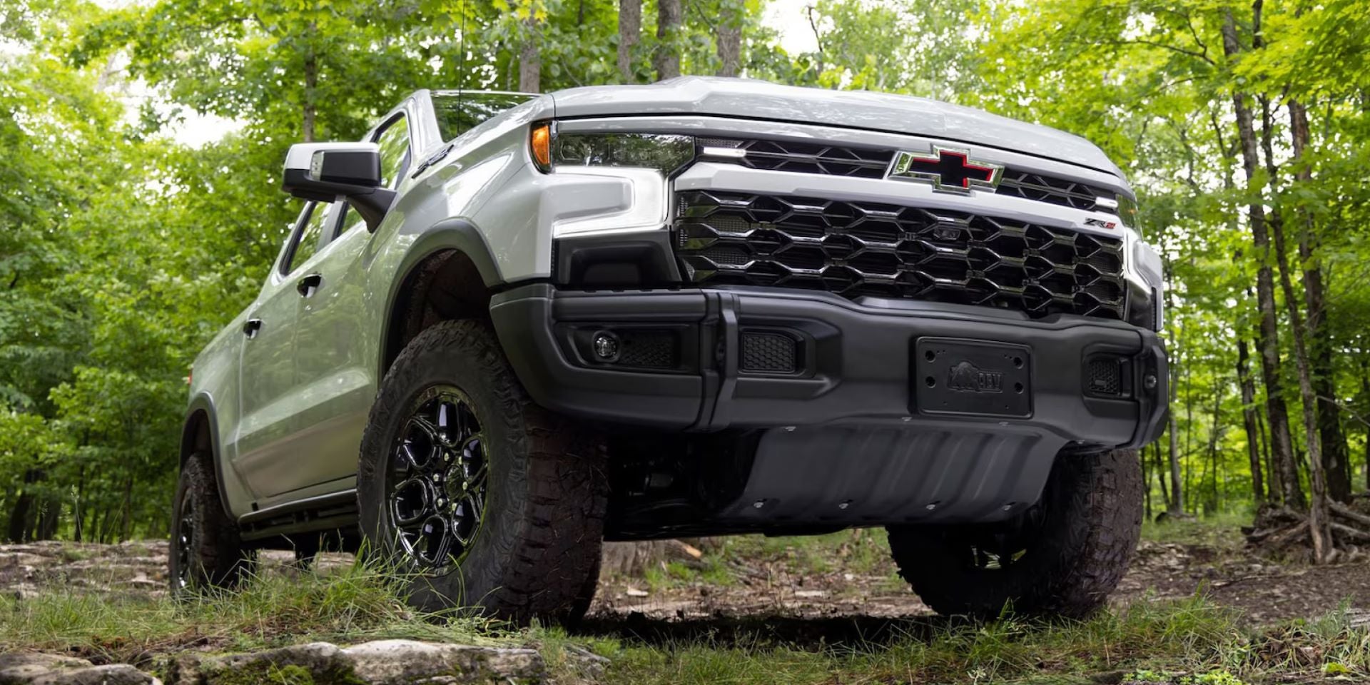 2025 Chevrolet Silverado front view from ground while driving in the woods