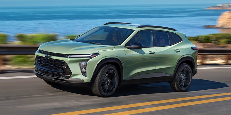 2025 Chevrolet Trax driving along the ocean on a sunny day