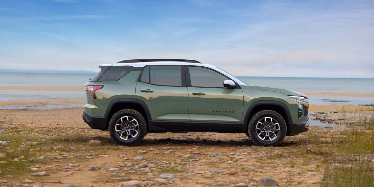 2025 Chevrolet Equinox side view in green parked in front of the ocean