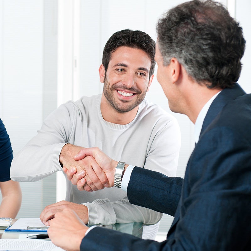 i.g. Burton Chevrolet of Seaford in Seaford DE customer shakings hands with a sales rep after purchasing a Chevrolet Silverado