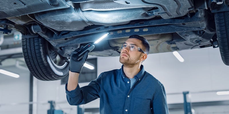 i.g. Burton Chevrolet of Seaford in Seaford DE close up of a technician looking under a vehicle